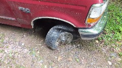 Car with destroyed tires blocking the road